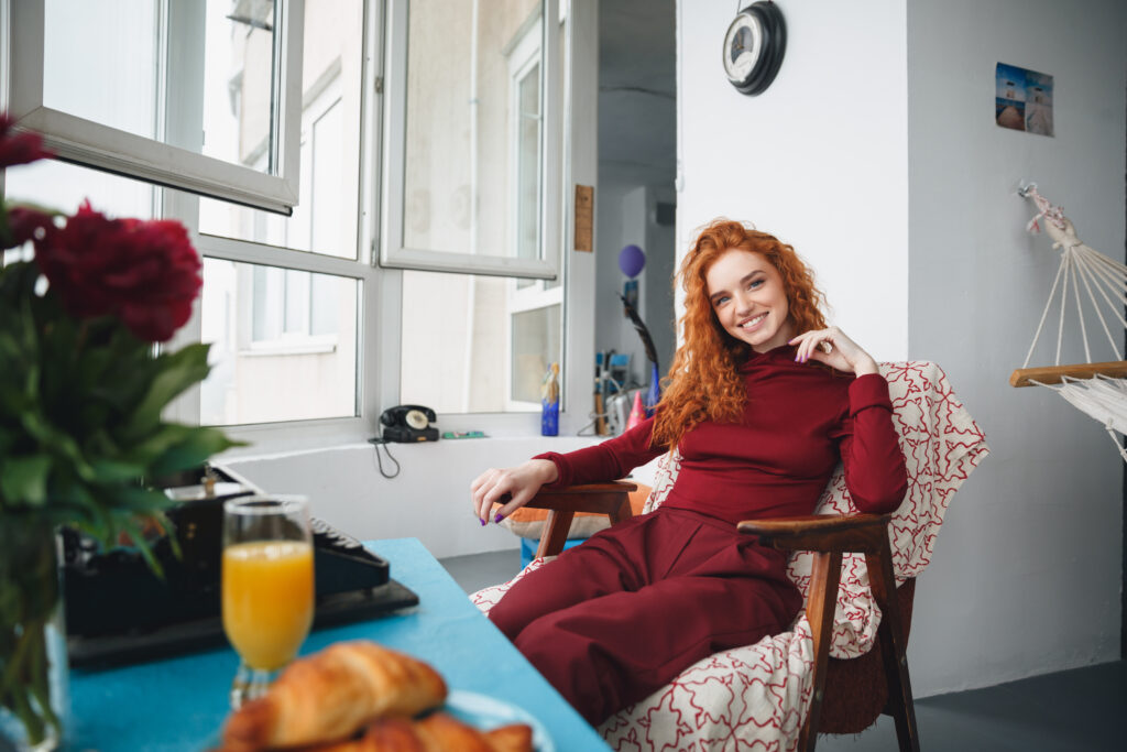 Portrait of a smiling pretty girl sitting on a chair