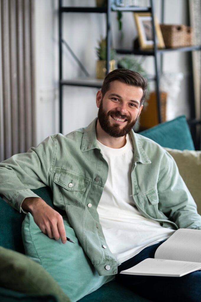 Medium shot man sitting indoors